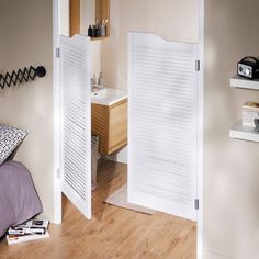 an open door leading to a bathroom and bedroom