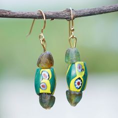 The exquisite artistry of the Ghanaian lands merges with Tina Quaye's love for the environment, creating these bold dangle earrings ideal for expressing your chic side. The artisan works with recycled glass beads to create each piece, adding a charming palette of green and yellow hues that will allow you to captivate everybody with a stylish grace. In addition, the earrings feature brass hooks. Yellow Hues, Brass Hooks, Tigers Eye Necklace, Recycled Glass Bead, Brass Hook, Tiger Eye Bracelet, Tiger Eye Beads, Bone Beads, Beaded Dangle Earrings