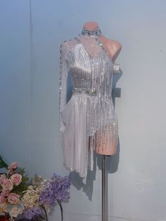 a mannequin is dressed up in silver sequins and beaded dress