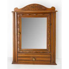 an antique wooden medicine cabinet with mirror