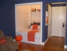 a bedroom with blue walls and wooden floors