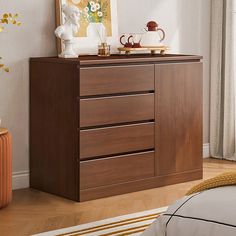 a wooden dresser in a bedroom next to a bed