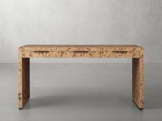 a wooden table sitting on top of a gray floor