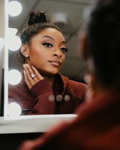 a woman looking at herself in the mirror