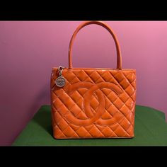 Classic Chanel Tote Bag In Patent Leather. This Is A Beautiful Bag, Well Structured. Orange In Color. This Is A Medium Sized Bag. Smoot Pink Leather Interior And A Silver Medallion Zipper Pull. Condition: Excellent With Some Minor Scuffs Or Marks As Shown In Pictures. Interior May Have Some Minor Scratches Too. Minor Creasing. Please Magnify Pictures To Evaluate. Chanel Medallion, Chanel Tote Bag, Classic Chanel, Chanel Tote, Medium Sized Bags, Chanel Bags, Pink Leather, Beautiful Bags, Leather Interior