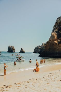 many people are on the beach and in the water