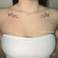 a woman's chest with two small leaves on it