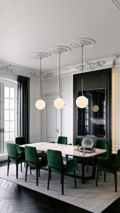 an elegant dining room with green chairs and chandelier