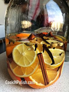 a pitcher filled with liquid and sliced lemons