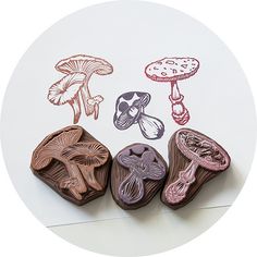 four rubber stamps with mushrooms on them in different colors and shapes, sitting on a white surface