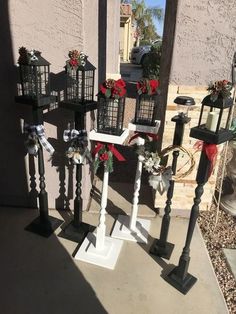 several black and white lanterns with red bows on them sitting in front of a building