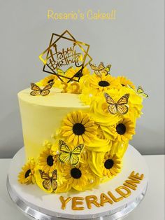 a yellow cake with sunflowers and butterflies on it that says yeraldin