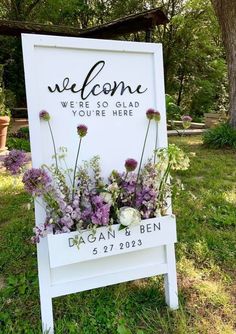 a welcome sign with flowers in it