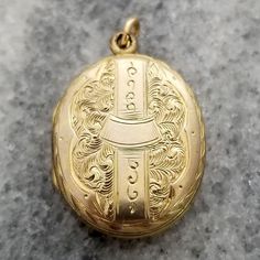 This is a lovely finely detailed antique oval shaped locket. The front and back are decorated in intricate etched designs. It opens up to reveal a compartment perfect for two photos. The locket measures 1 1/8 inch (29.33mm) tall, including loop 11/16 inch (19.22mm) wide It is unmarked but appears to be yellow gold filled. It weighs 3.5 grams It is in good wearable condition, it does show some signs of wear from being a piece of vintage estate jewelry. All it needs is a chain to hang from (chain in photos not included). Please inspect photos closely before purchasing. This item will be shipped fully insured in the US. Just send me a message if you have any questions. Victorian Oval Necklaces With Antique Finish, Victorian Oval Necklace With Antique Finish, Elegant Oval Pendant Locket Necklace From Vintage Collection, Elegant Oval Pendant Locket Necklace For Vintage Collection, Victorian Oval Locket Necklace With Vintage Charm, Oval Victorian Locket Necklace With Vintage Charm, Ornate Oval Locket Necklace From Vintage Collection, Heirloom Style Oval Pendant Locket Necklace With Vintage Charm, Victorian Locket Necklace With Oval Pendant