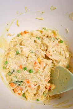 a white bowl filled with food and a spoon