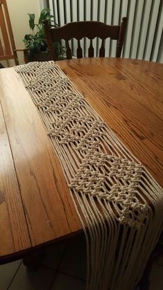 a wooden table topped with a woven runner