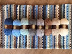 several skeins of yarn are lined up on a table