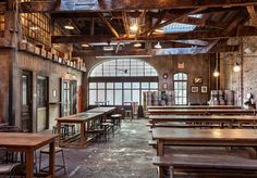 the inside of an old building with tables and benches