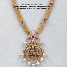 a gold necklace with pearls and other jewels