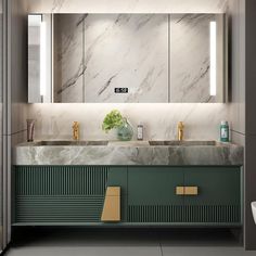 a bathroom with marble counter tops and green cabinets