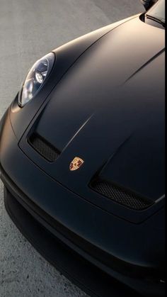 the front end of a black sports car