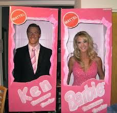 two cardboard barbie dolls are shown in front of a man and woman's face