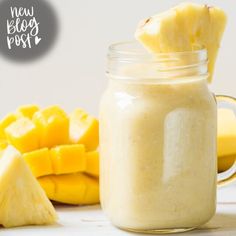 a glass jar filled with food next to sliced pineapples