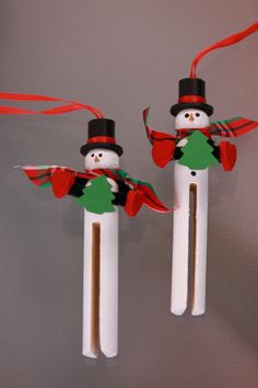 two snowmen made out of toothpicks on sticks