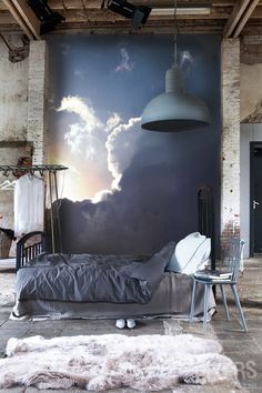 a bedroom with a large mural on the wall