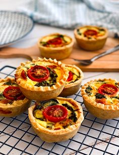 several small quiche pies on a cooling rack