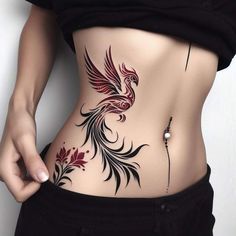 a woman's stomach with a bird tattoo on it