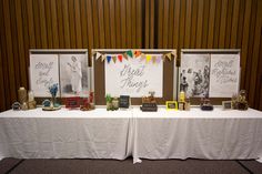 the table is set up with pictures and other items on it for guests to sign