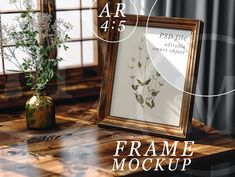 a wooden table topped with a vase filled with flowers next to an empty frame mockup