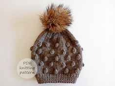 a knitted hat with a pom - pom on top