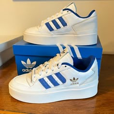 Classic Adidas 3-Stripes Style In A Trendy Platform Sneaker! The Forum Bonega Has A Premium Leather Upper, Memory Foam Sockliner (Comfy), And Rubber Platform Outsole. All White With Blue 3-Stripes And A Gold Adidas Trefoil Logo On Side. Regular Fit. Nwt Comes In Original Adidas Box. Ol5ss5x1a7 Forum Bonega Shoes, Bonega Shoes, Shoes Adidas Women, Best Work Shoes, Dressing Shoes, Shoes Dressing, Storage Shoes, Shoe Outfits, Shoe Storage Ideas