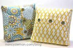 two yellow and blue pillows with buttons on the front one has a flower print design