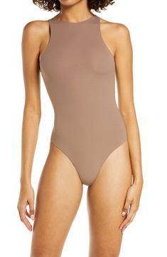 Sculpt your body's natural shape with a high-neck bodysuit from Kim Kardashian West's SKIMS that holds you in and lifts you up in all the right places. Reflecting the brand's passion for highly technical shapewear solutions for every body, this everyday piece has whisper-soft, seamless construction, high-cut legs and a thong back that remains invisible under clothing. Style Name:Skims Fits Everybody High Neck Bodysuit (Regular & Plus Size). Style Number: 6125046. High Neck Smoothing Bodysuit In Solid Color, Sleek Second-skin Turtleneck Bodysuit, Sleek Turtleneck Second-skin Bodysuit, High Stretch Smoothing Bodysuit, High Neck Elastane Bodysuit, Seamless High Neck Bodysuit In Solid Color, High Neck Bodysuit With Minimal Stretch, Solid High Neck Bodysuit With Minimal Stretch, Sleek High Stretch Turtleneck Bodysuit