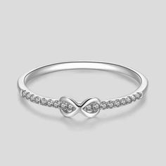 "So elegant is this infinity style diamond ring, perfect for everyday wear as the diamond gives just the right amount of sparkles to your finger. Absolutely perfect for any occasion and stacks well with other ring styles. Ring features: Metal: Available in solid white, yellow, or rose gold 14k. - Ring Width: Approximately 1.3 mm - Diamond Shape: Round - Number of Stones: 18 of Mined Diamond (100% Real Diamonds ) - Diamond Size: 1.1 mm - Total CTW: 0.08 Ctw - Diamond Color-Clarity: G - H Color SI Classic Infinity Ring For Anniversary, Classic Infinity Ring With Cubic Zirconia, Classic Infinity Diamond Promise Ring, Classic Infinity Cubic Zirconia Rings, Classic Infinity Rings In Diamond White, Classic Infinity Ring In Diamond White, Anniversary Infinity Diamond Ring With Prong Setting, Infinity Ring With Brilliant Cut For Anniversary, Classic Infinity Diamond Ring For Anniversary