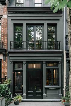 an apartment building with black doors and windows in new york city, ny on the street