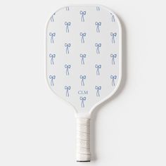 a white paddle with blue bows on it