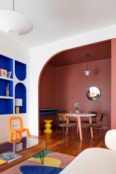 a living room filled with furniture and colorful walls