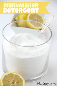 a glass bowl filled with white powder next to two lemons