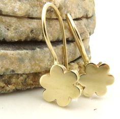 "These solid gold earrings are classic, naive and have the basic flowery shape. These 14k gold flower earrings are timeless and would look great on women at any age, these dangle earrings can make for a multi generation family present for a mother, daughter and a grandmother. They will look beautiful on a bride in white but even more so for the bridesmaids. Its classic shape and simplicity means you can wear it with all kinds of clothing. Theses earrings are made to order in 7-10 days. Dimension Flower Earrings Dangle, Gold Ruby Necklace, Gold Flower Earrings, Family Presents, Aquamarine Earrings, Ruby Pendant, Solid Gold Earrings, Gold Flower, Handmade Gold