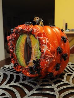 an eyeball decorated with spider webs sits on a table