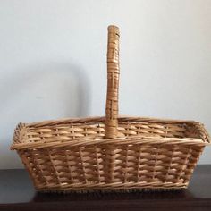 a wicker basket sitting on top of a wooden table