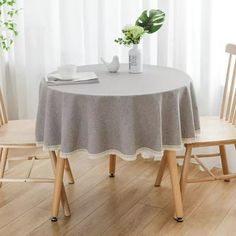 a table with two chairs and a potted plant sitting on top of the table