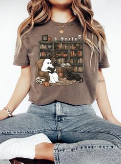 Embrace spooky season in style with this Retro Ghost Reading Book Shirt! This fun and quirky Ghost Halloween Shirt is perfect for teachers, book lovers, and anyone who enjoys a blend of Halloween spirit and cozy comfort. The high-quality Comfort Colors® Women Fall T-Shirt provides a soft, unisex fit that is perfect for autumn days. Featuring a charming ghost reading a book, this Teacher Graphic Tee is ideal for showing off your love for both Halloween and literature. Whether you're wearing it to Ghost Reading Book, Ghost Reading, Retro Ghost, Book Shirt, Trendy Fits, Presents For Teachers, Ghost Shirt, Autumn Coffee, Book Shirts