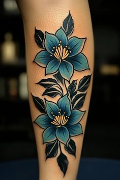 a woman's leg with blue flowers on it