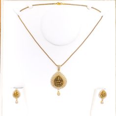 Embrace luxury with our Impressive Lakshmi 22k Gold CZ Pendant Set. Crafted from 14.5g of pure 22k gold, adorned with dazzling Cubic Zirconia. The pendant boasts a 2.2" length, complemented by matching 1" earrings with secure screw backs. Elevate your style with this exquisite 3-piece set. PRODUCT DETAILS Gold Purity(karat): 22k Item Weight(grams): 14.5 Item Finish: Yellow Gold Stone: Cubic Zirconia Pendant Length: 2.2" Matching Earrings: Included Earring Length: 1" Earring Post: Screw Back Numb Gold Bollywood Jewelry Sets With Cubic Zirconia, Bollywood Style Gold Cubic Zirconia Jewelry Sets, Gold Cubic Zirconia Bollywood Jewelry Sets, Gold Diamond Temple Necklace For Wedding, Festive Gold Temple Necklace With Diamonds, Festive Gold Diamond Temple Necklace, Gold American Diamond Jewelry Sets For Diwali, Gold Diamond Jewelry Sets For Festive Occasions, Diwali Gold Jewelry Sets With American Diamonds