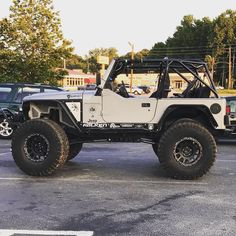 a white jeep parked in a parking lot